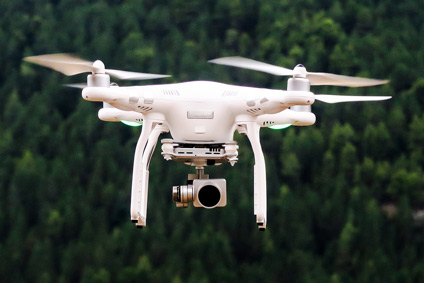 DJI Phantom Drone In Flight Over Wooded Area.